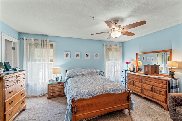 bedroom featuring carpet flooring, ceiling fan, and multiple windows