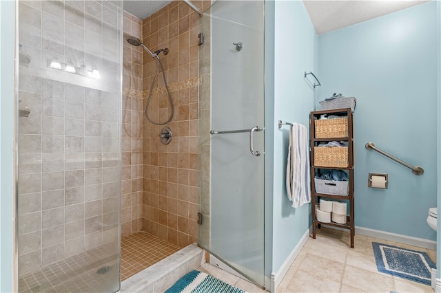 bathroom with a textured ceiling, toilet, tile patterned floors, and walk in shower