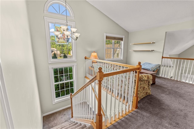 stairs with high vaulted ceiling, carpet flooring, and a notable chandelier