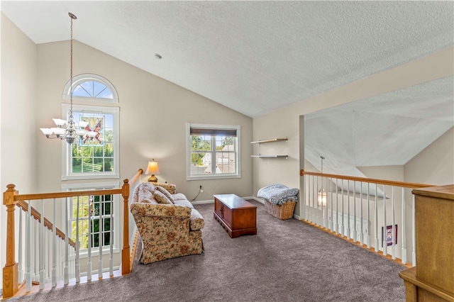 sitting room with vaulted ceiling, a textured ceiling, a chandelier, and carpet floors