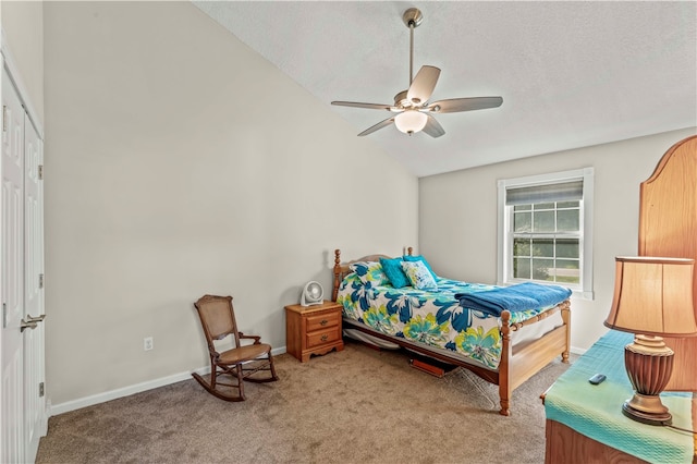 bedroom with vaulted ceiling, a closet, carpet, ceiling fan, and a textured ceiling