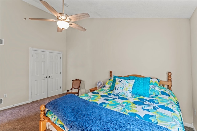 carpeted bedroom with ceiling fan, a closet, and vaulted ceiling