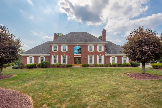 colonial-style house with a front yard