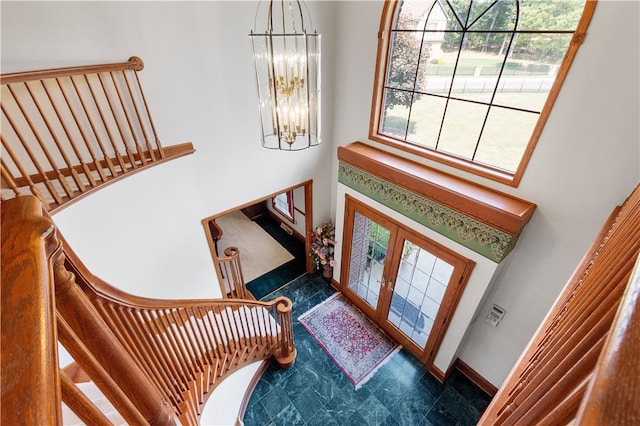 foyer with a towering ceiling and an inviting chandelier