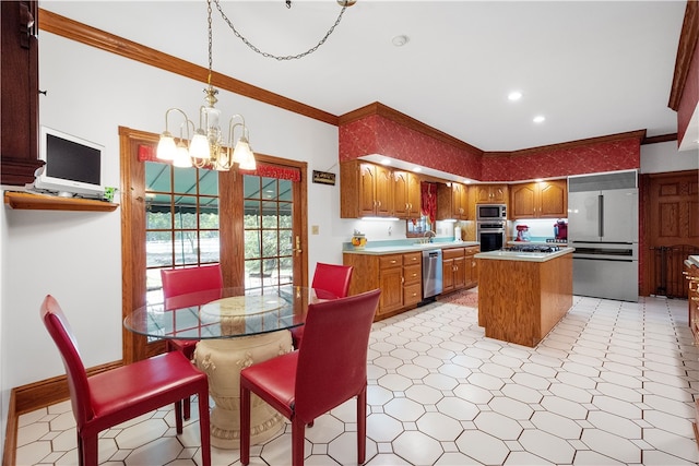 kitchen featuring built in appliances, a kitchen island, a chandelier, and crown molding