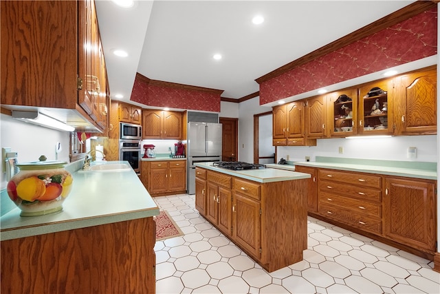 kitchen with a kitchen island, ornamental molding, sink, and appliances with stainless steel finishes