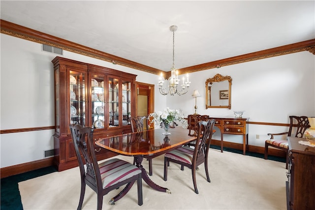 dining space featuring ornamental molding, a notable chandelier, and light colored carpet