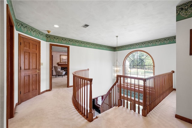 interior space featuring light colored carpet and a chandelier