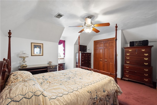 bedroom featuring lofted ceiling, dark carpet, ceiling fan, and a closet