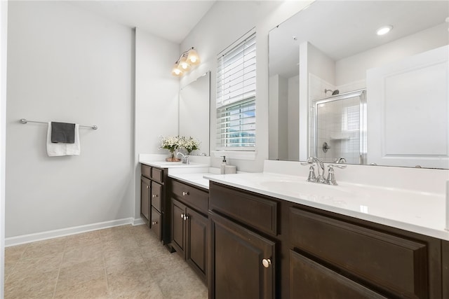 bathroom with a shower with door and vanity