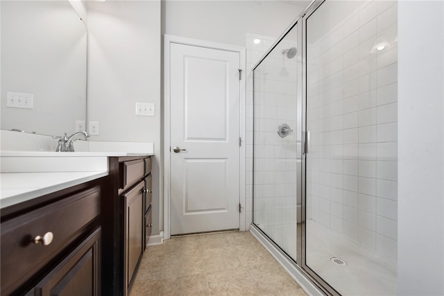 bathroom with vanity, an enclosed shower, and tile patterned floors