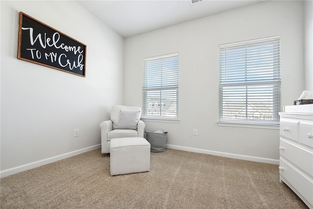 living area featuring light carpet