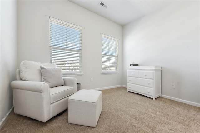 sitting room featuring light carpet