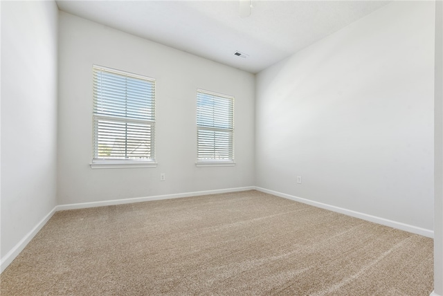 empty room featuring light colored carpet