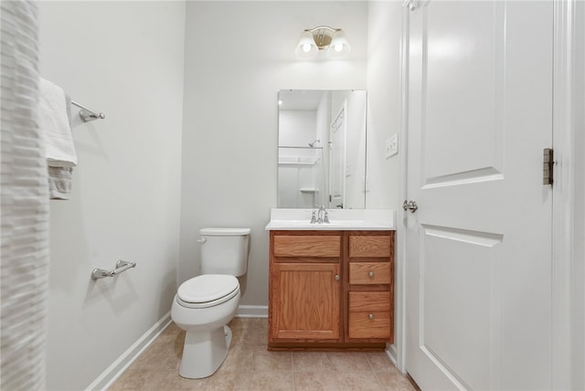 bathroom with tile patterned flooring, vanity, and toilet