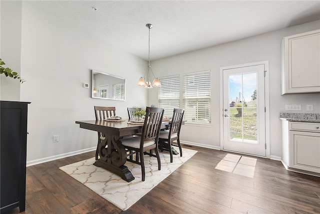 dining area featuring a chandelier and dark hardwood / wood-style floors