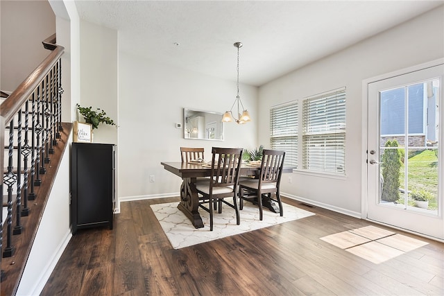 dining area with dark hardwood / wood-style flooring, a chandelier, and a textured ceiling