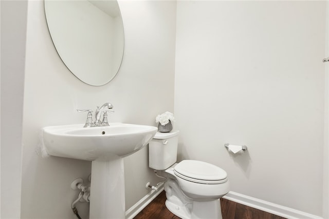 bathroom featuring toilet and wood-type flooring