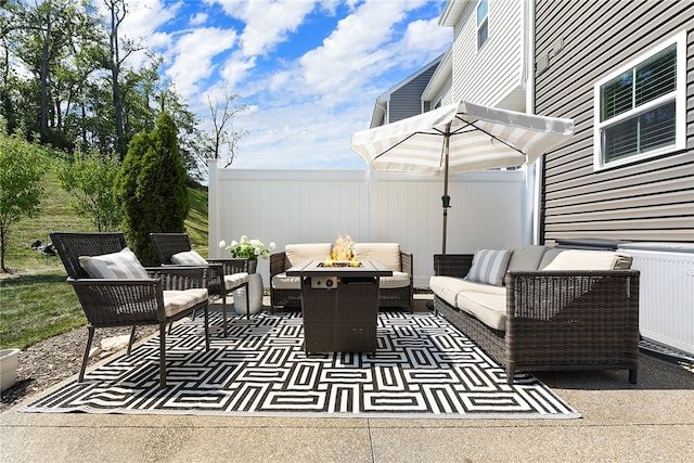 view of patio / terrace featuring an outdoor living space with a fire pit