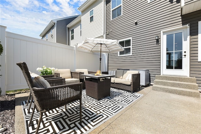 view of patio with an outdoor living space with a fire pit