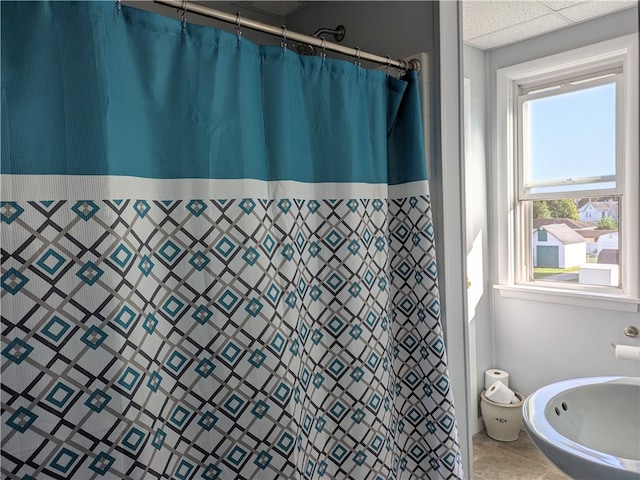 bathroom featuring a shower with curtain and tile patterned flooring