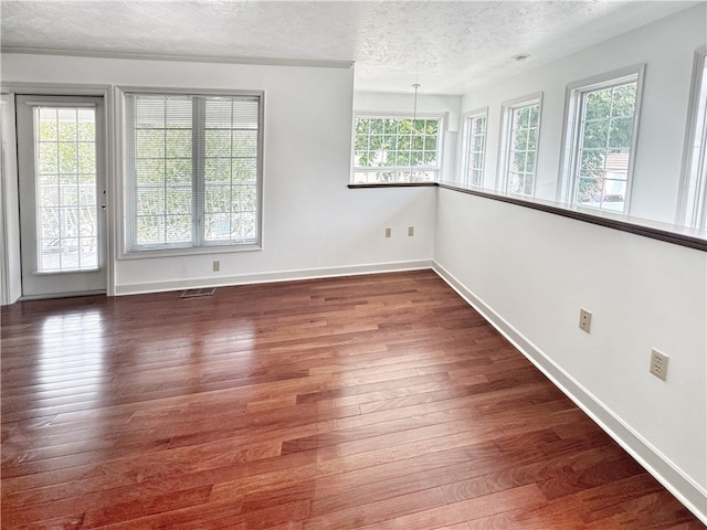 interior space featuring dark wood-type flooring and a textured ceiling