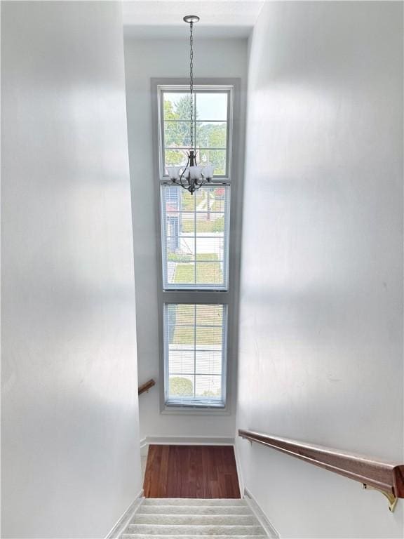 740 Turnpike St Unit 5, Beaver, PA 15009 - staircase featuring an inviting chandelier, wood finished floors, and baseboards