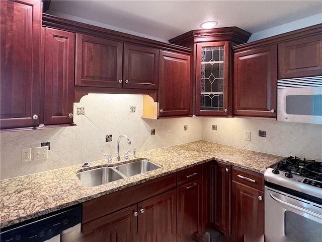 740 Turnpike St Unit 5, Beaver, PA 15009 - kitchen with tasteful backsplash, glass insert cabinets, a sink, appliances with stainless steel finishes, and light stone countertops