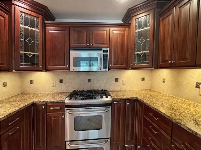 740 Turnpike St Unit 5, Beaver, PA 15009 - kitchen featuring glass insert cabinets, appliances with stainless steel finishes, and light stone counters
