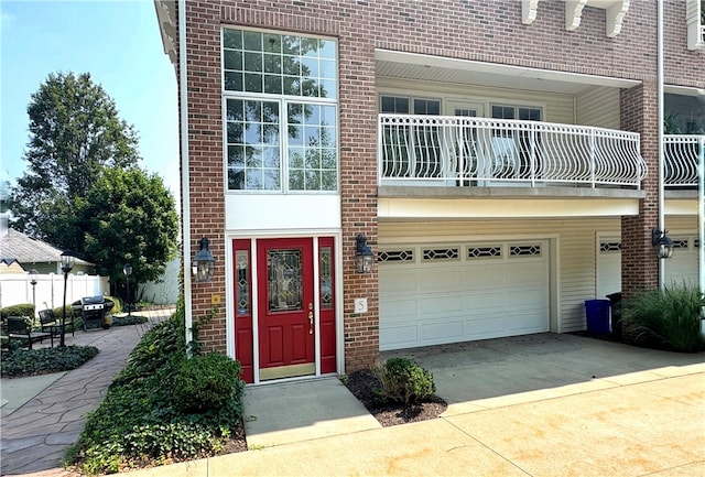 view of front of property featuring a balcony and a garage