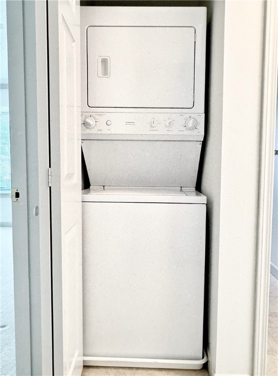 laundry area featuring stacked washer and clothes dryer