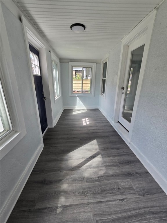 hall with wooden ceiling and dark hardwood / wood-style floors