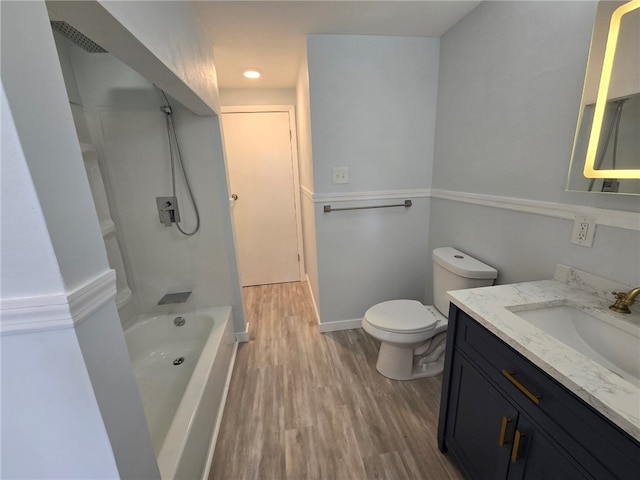 full bathroom with vanity, toilet, wood-type flooring, and bathing tub / shower combination