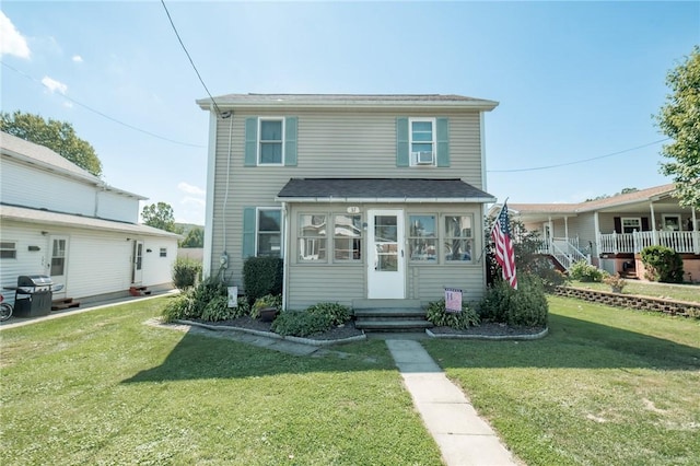 view of front of home featuring entry steps and a front lawn