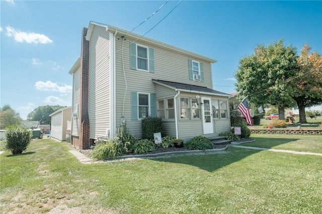 view of front of property featuring a sunroom, a front yard, and entry steps