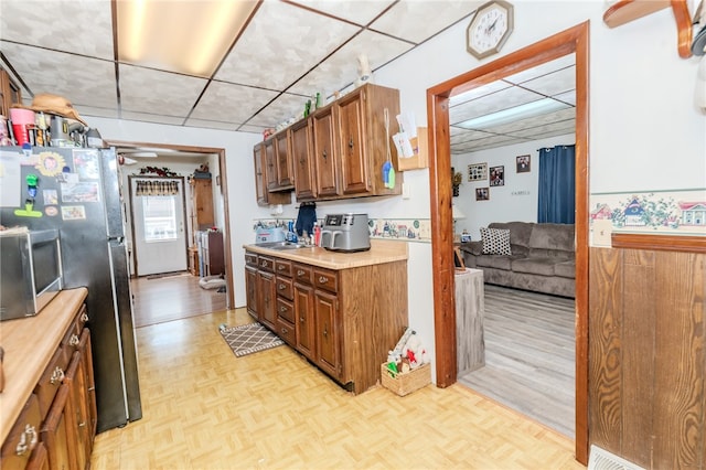 kitchen featuring light parquet flooring, ceiling fan, and sink