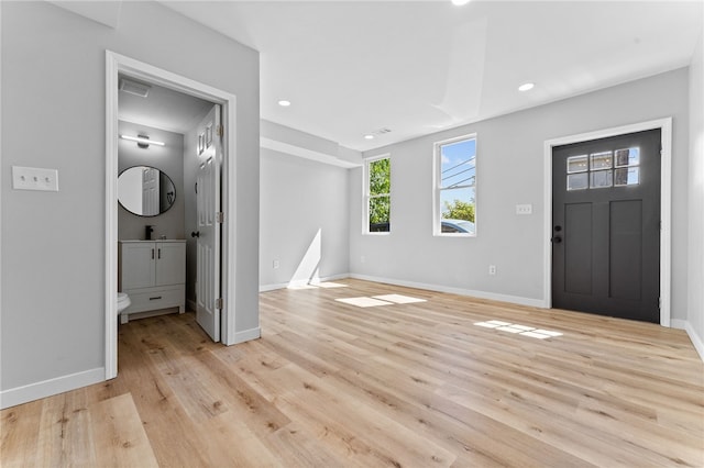 foyer featuring recessed lighting, baseboards, and light wood-style floors