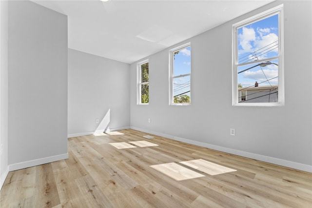 spare room featuring wood finished floors and baseboards