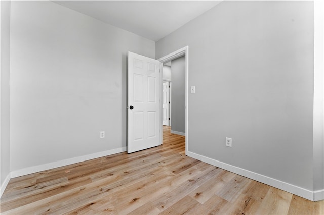 empty room featuring baseboards and wood finished floors