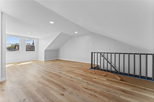 bonus room featuring recessed lighting, baseboards, lofted ceiling, and wood finished floors