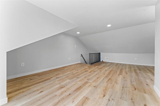 bonus room featuring wood finished floors, baseboards, visible vents, lofted ceiling, and recessed lighting