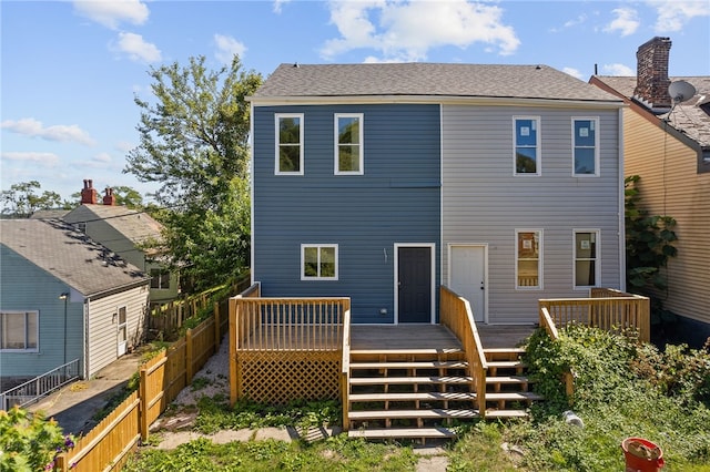 back of property featuring a wooden deck, stairs, and fence