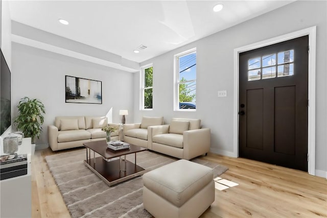 living area featuring recessed lighting, visible vents, baseboards, and wood finished floors