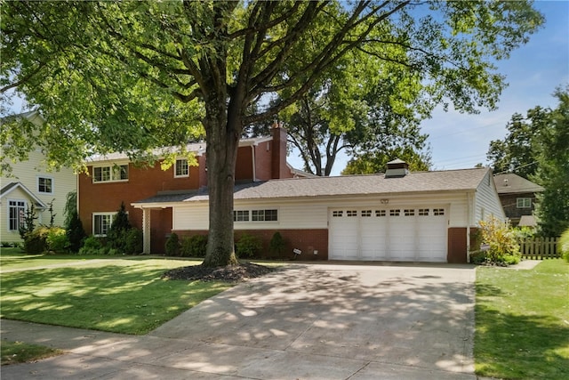 view of front of property with a garage and a front lawn