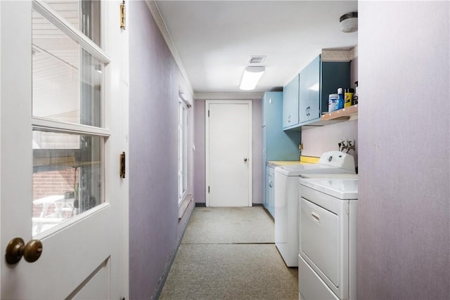 laundry area with visible vents, baseboards, washer and dryer, and cabinet space