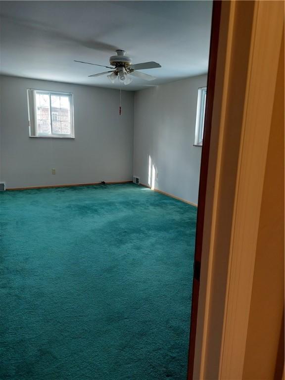 carpeted empty room with ceiling fan