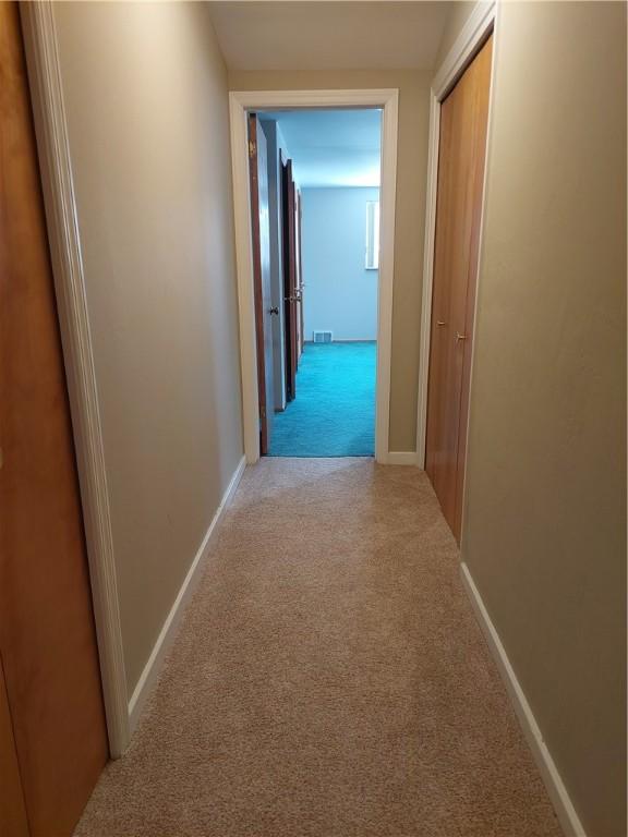 corridor with light carpet