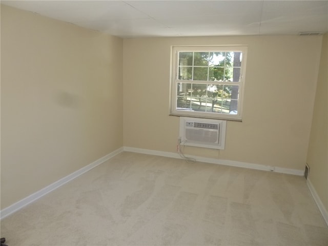 carpeted spare room featuring a wall mounted AC