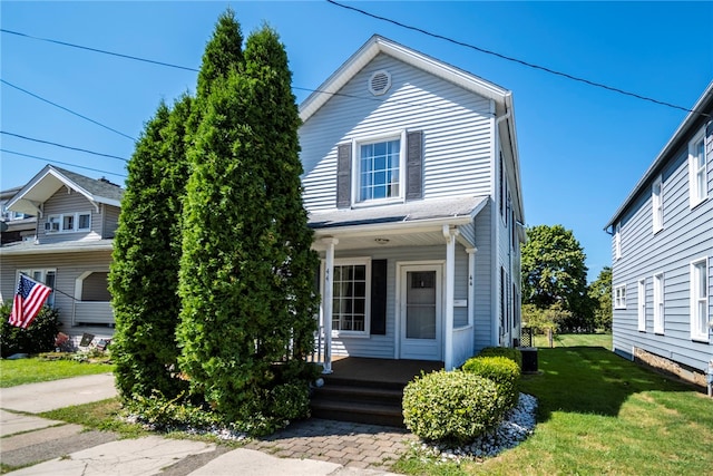 view of front facade with covered porch and a front lawn