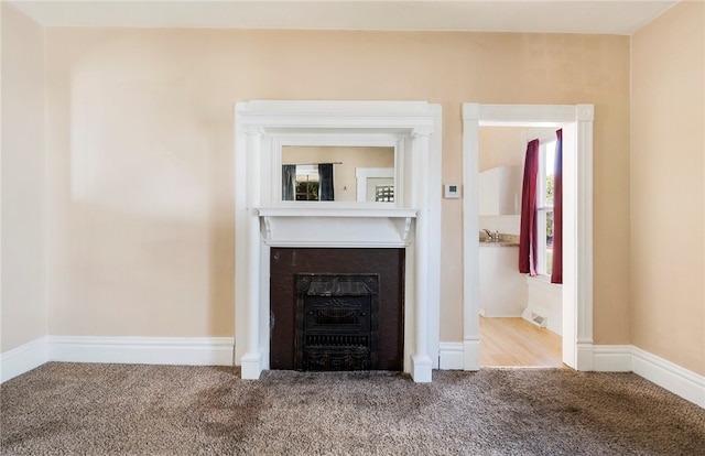 unfurnished living room featuring carpet floors and a fireplace